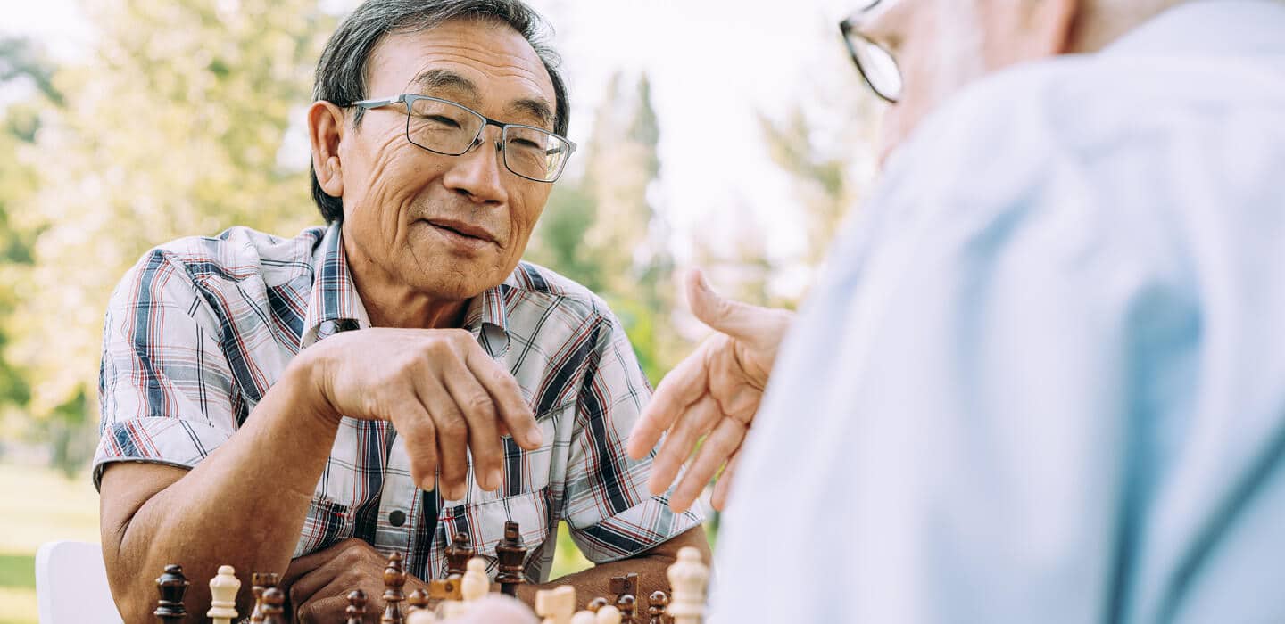 elderly men playing chess
