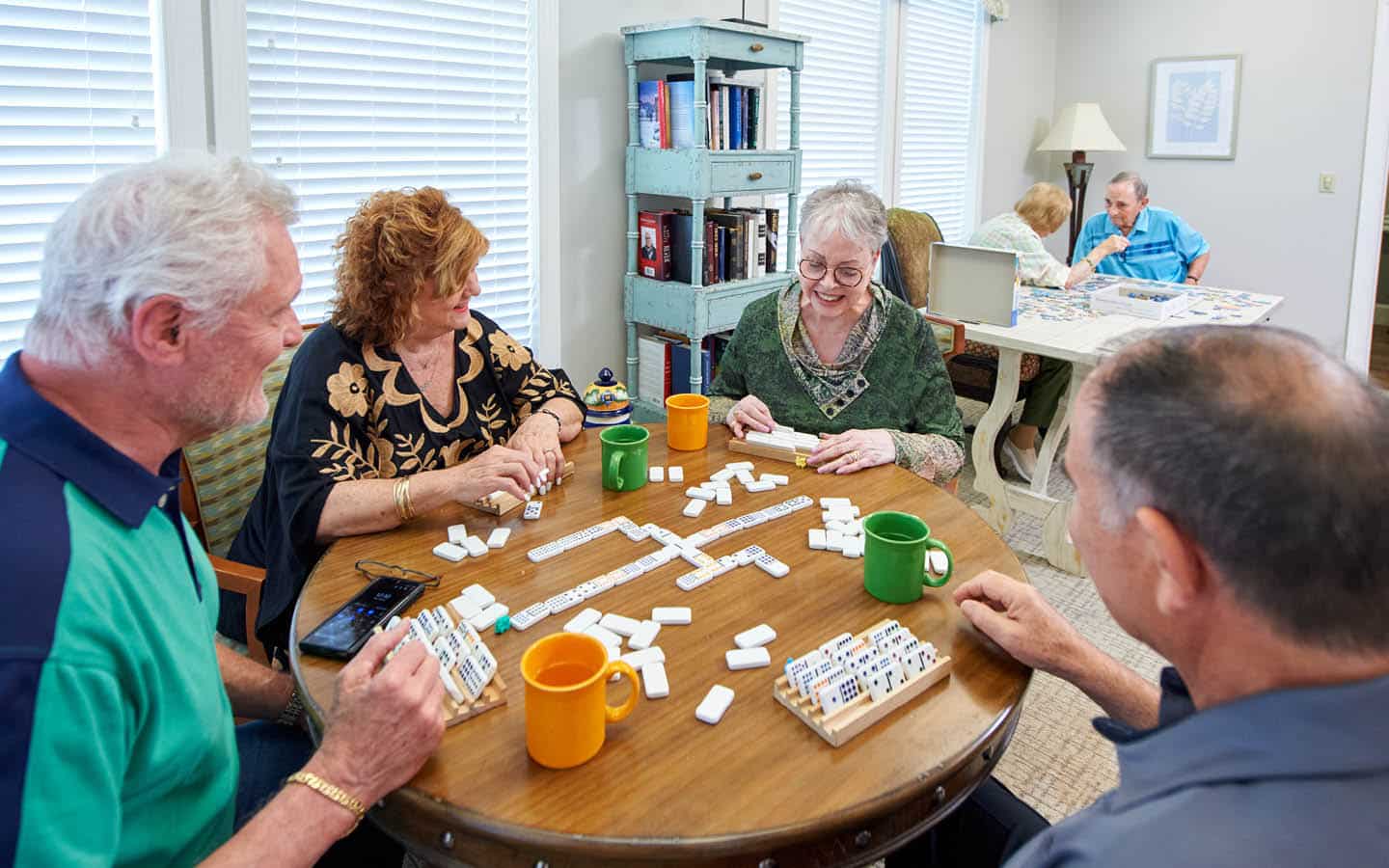 friends having a laugh while playing dominos