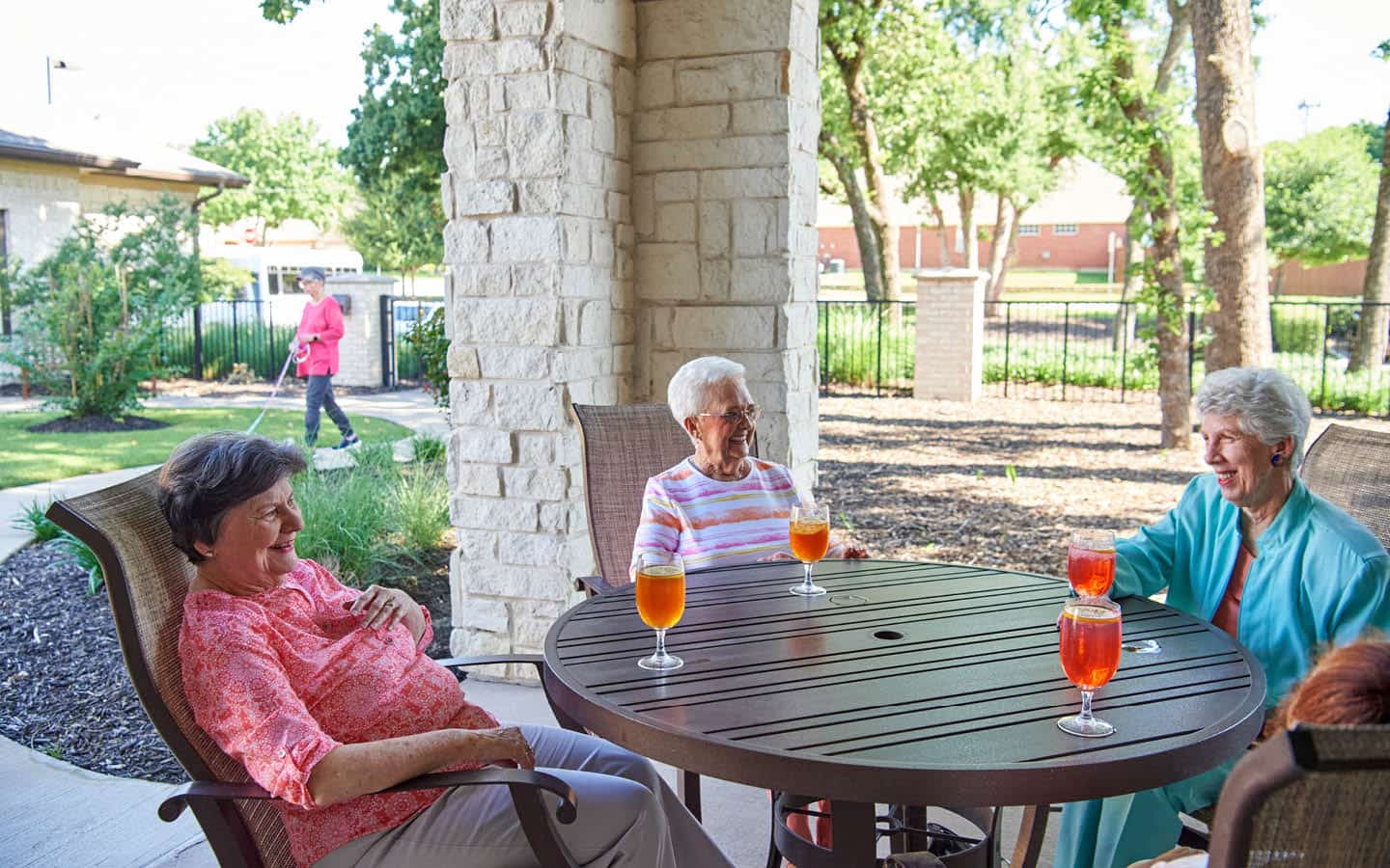 friends sharing stories and drinks at an outside sitting area