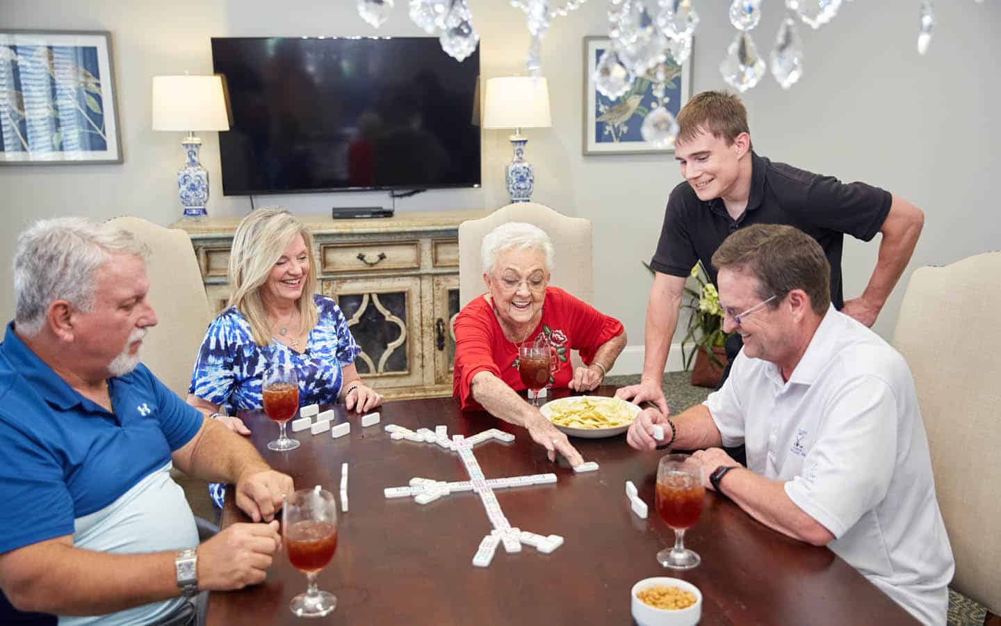 friends having a laugh while playing dominos